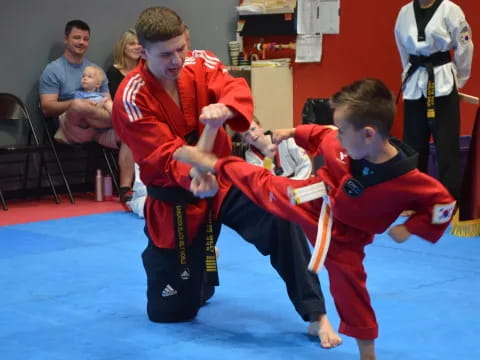 a group of boys in red karate uniforms