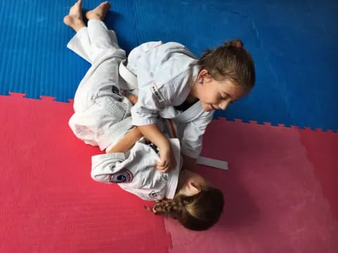 a boy and girl in karate uniforms