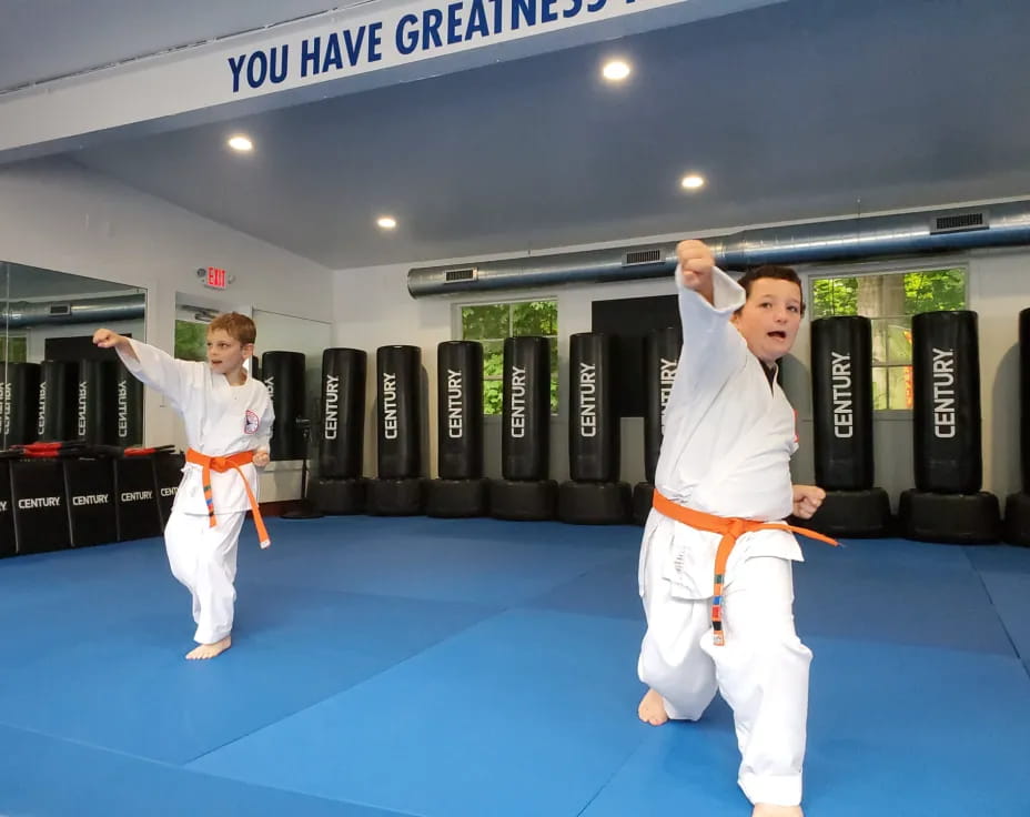 a couple of men in karate uniforms