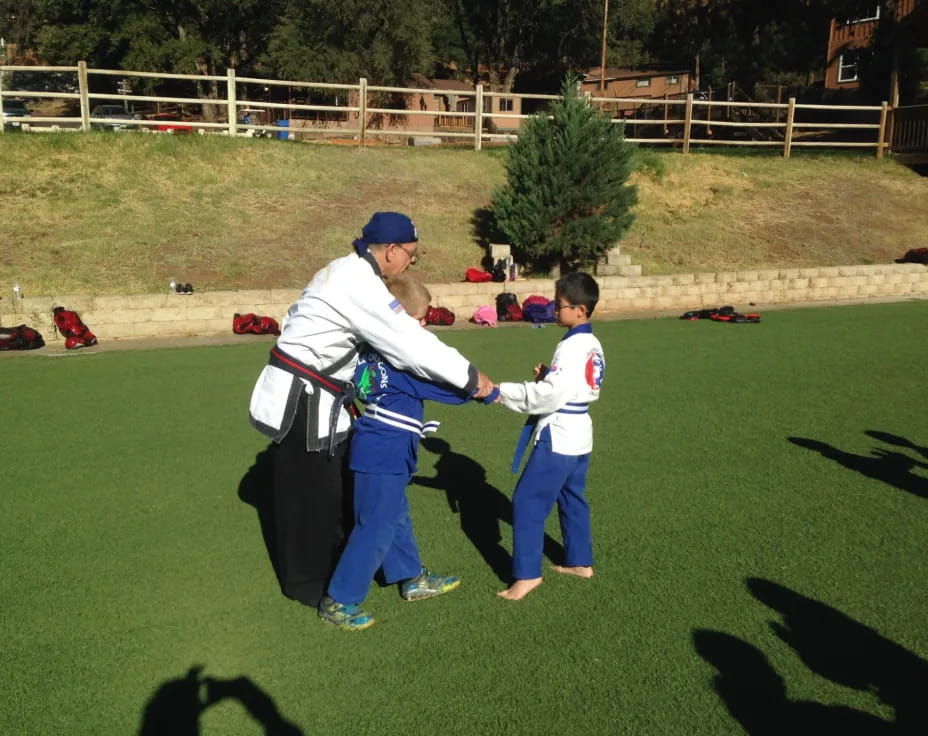a person and a boy playing baseball