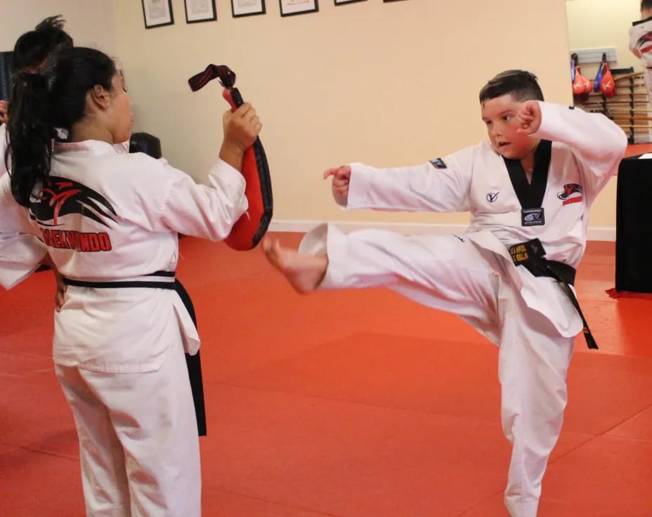 a man and woman in karate uniforms