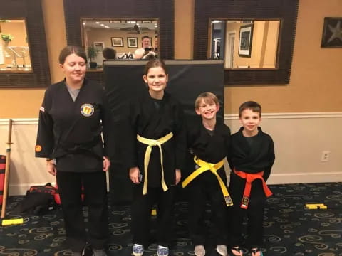 a group of people holding yellow and black objects