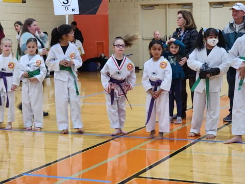 a group of people in karate uniforms