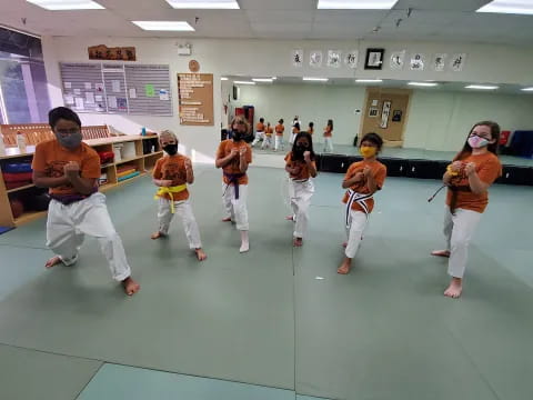 a group of people in a karate class