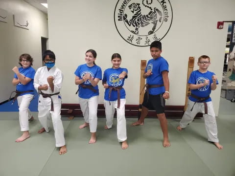 a group of people in blue karate uniforms