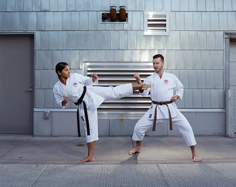 a man and woman in karate uniforms