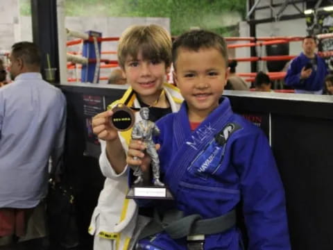 a couple of boys holding trophies