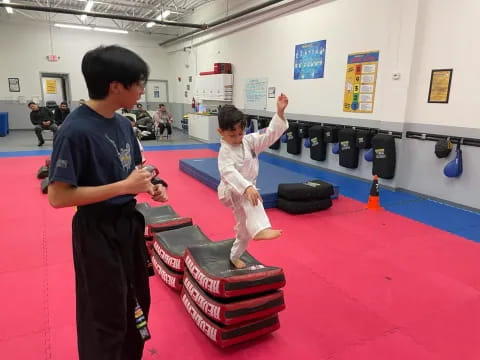 a person and a boy in a gym