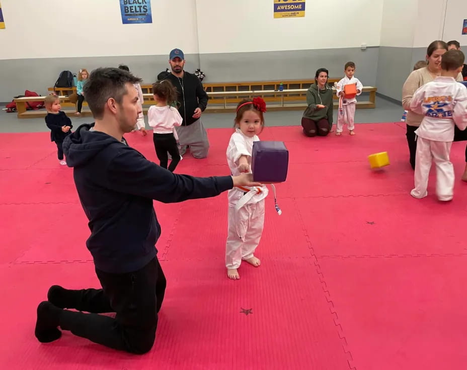 a person and a girl in karate uniforms