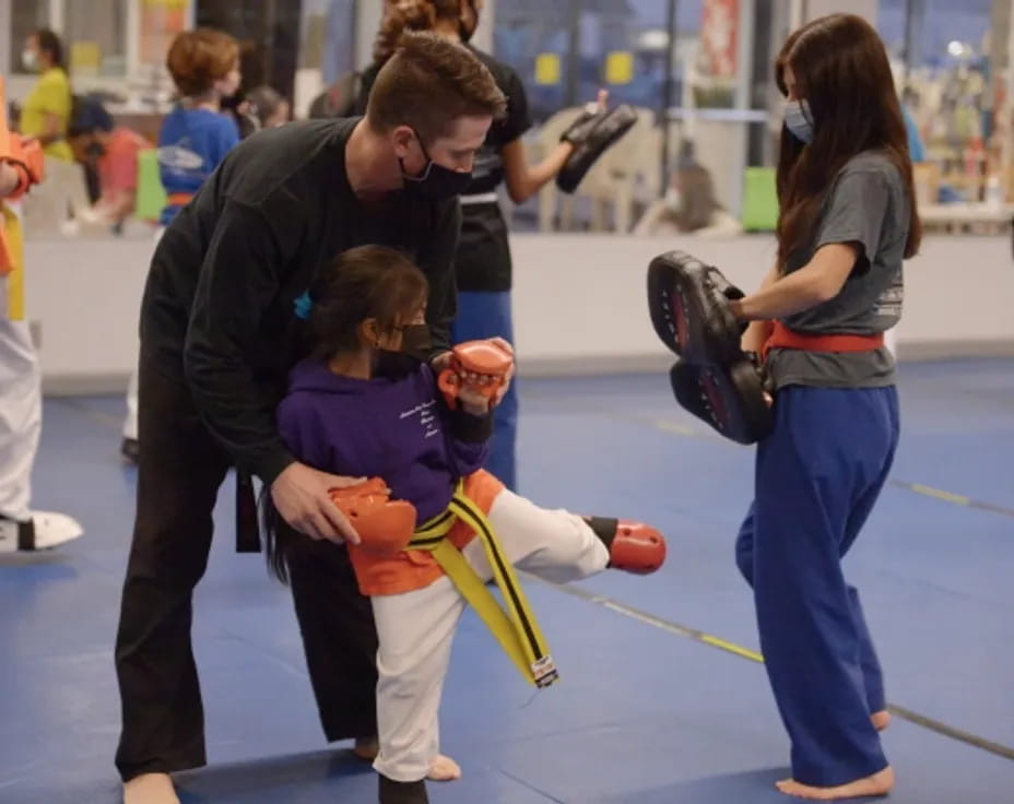 a person helping a girl with a rope