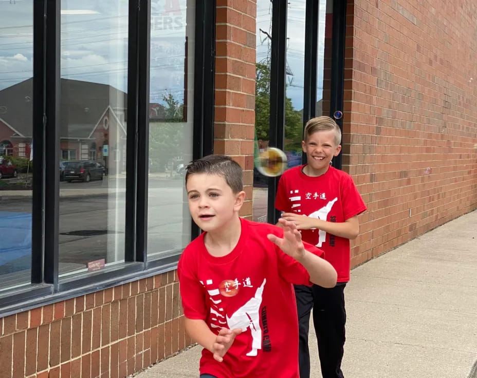 a couple of boys in red shirts