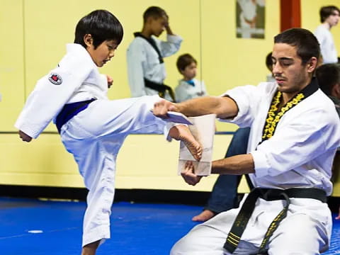 a couple of boys in karate uniforms