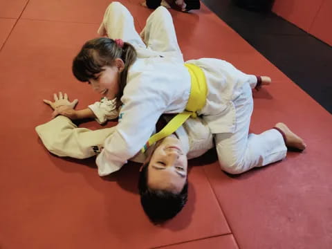 a man and woman in karate uniforms