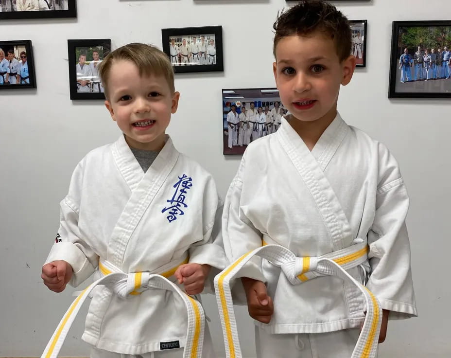 two boys wearing karate uniforms