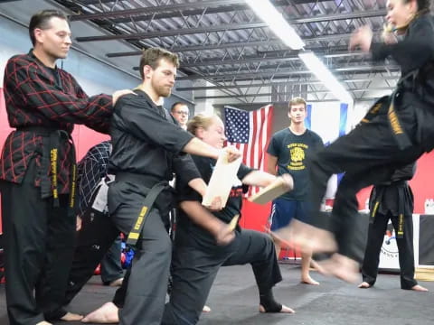 a group of people in black martial arts uniforms