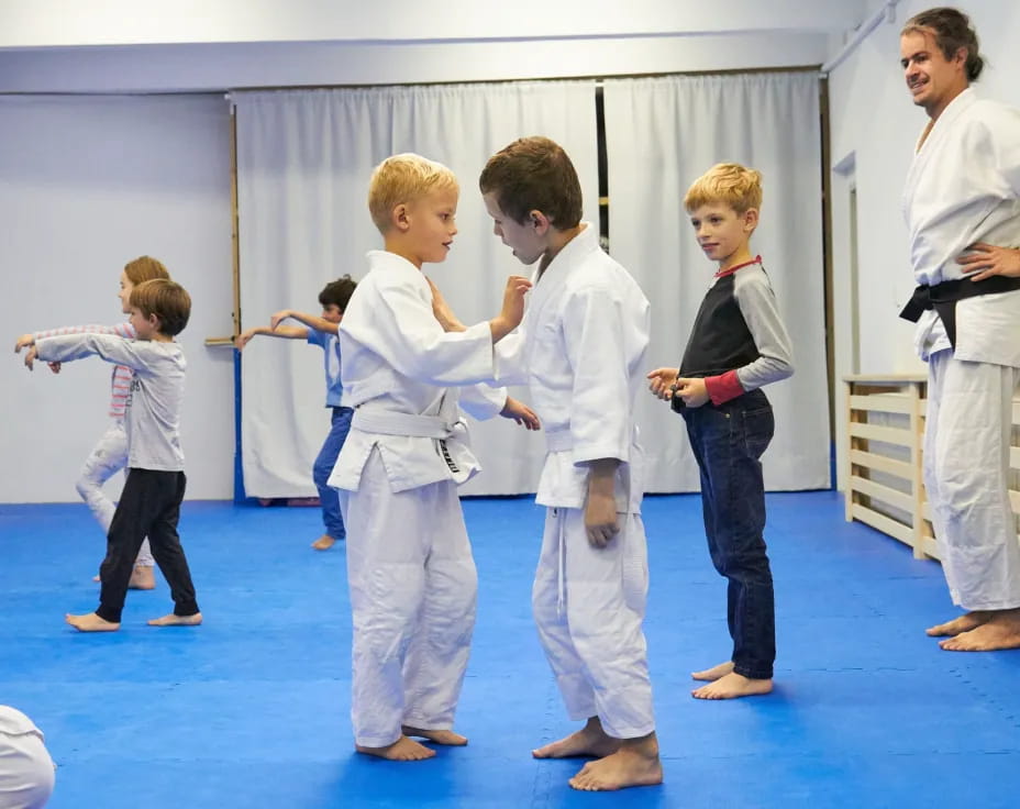 a group of people in karate uniforms