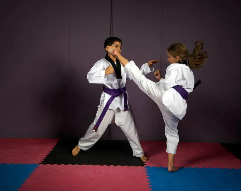 a man and woman in karate uniforms