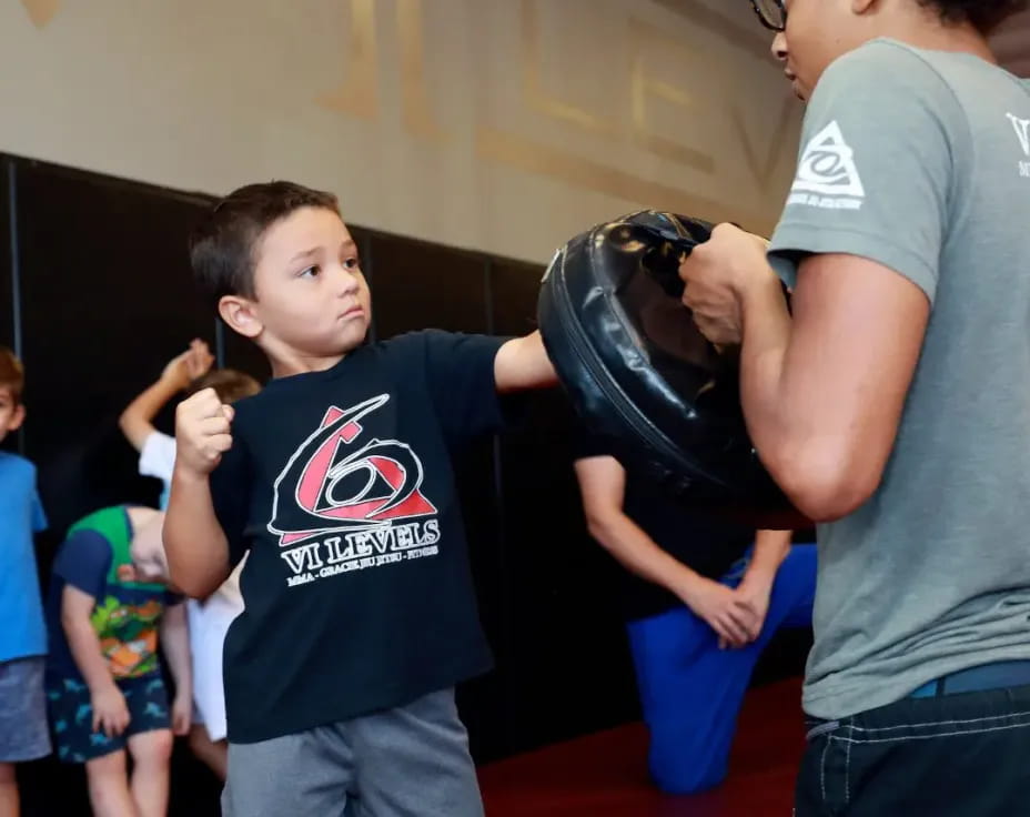 a person and a boy holding a helmet