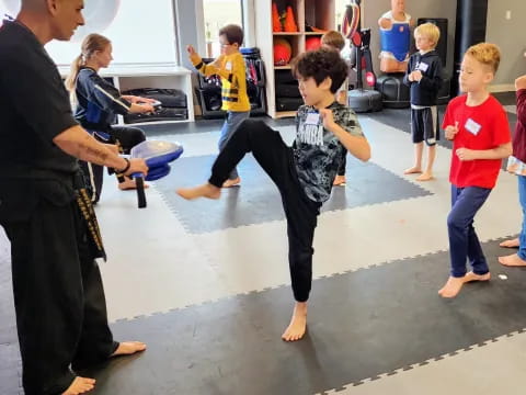 a person kicking a boy in the air