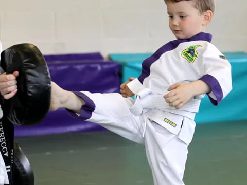 a boy in a karate uniform