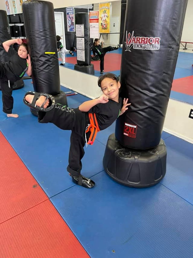 a boy doing a handstand on a barbell