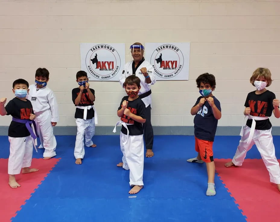 a group of kids in karate uniforms