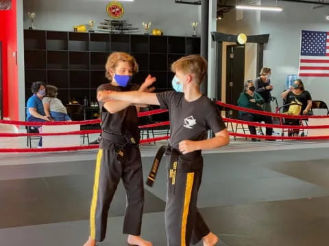 a couple of boys in a boxing ring