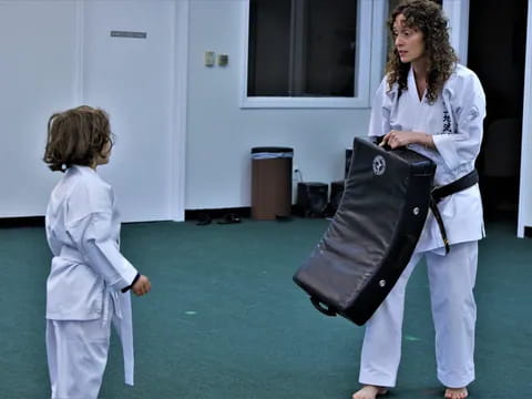 a person and a child in karate uniforms