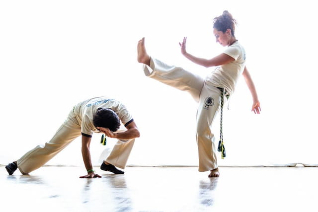 a man kicking another man