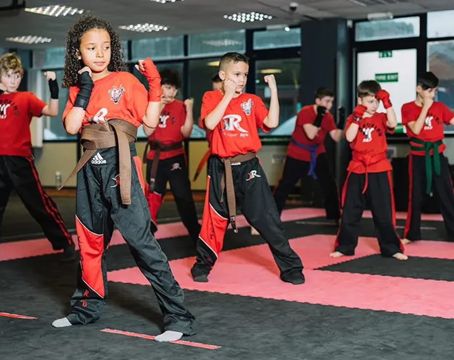 a group of kids in red shirts