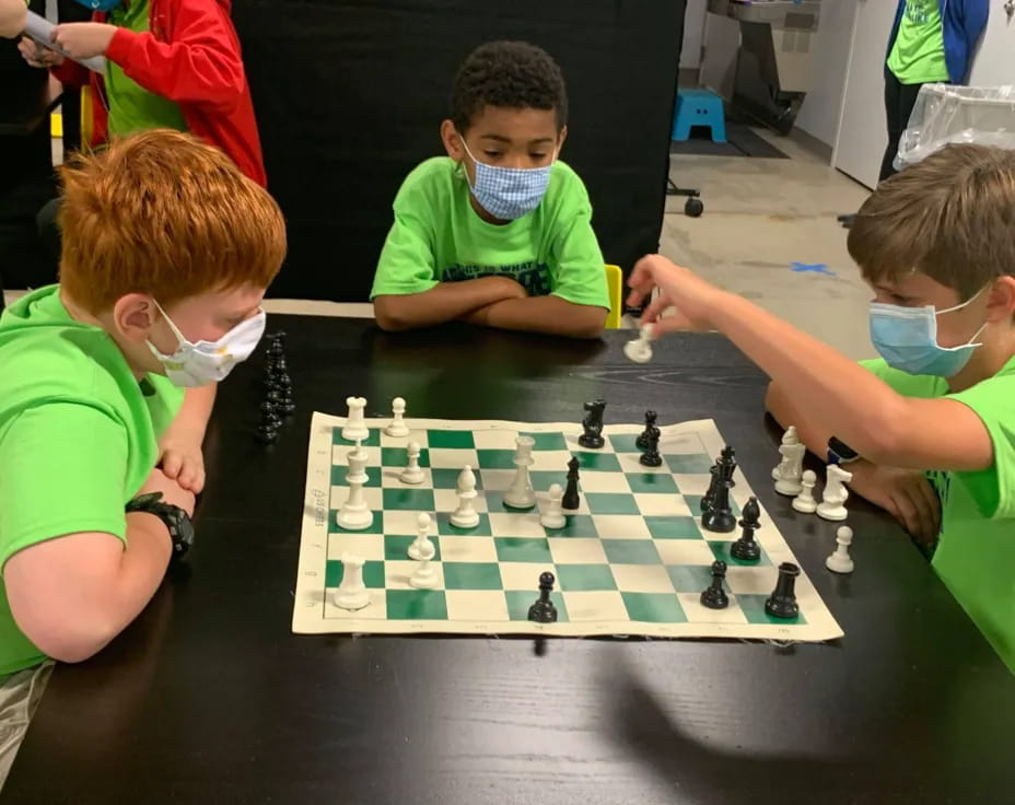 a group of boys playing chess