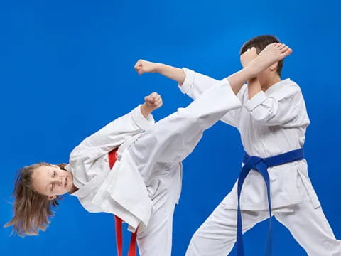 a man and woman in karate uniforms