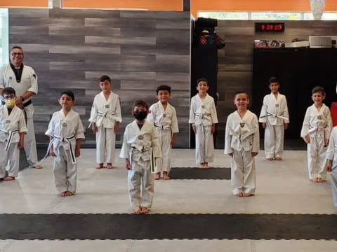 a group of people in white karate uniforms