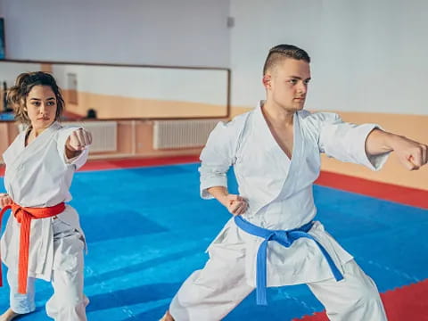 a man and a woman in karate uniforms