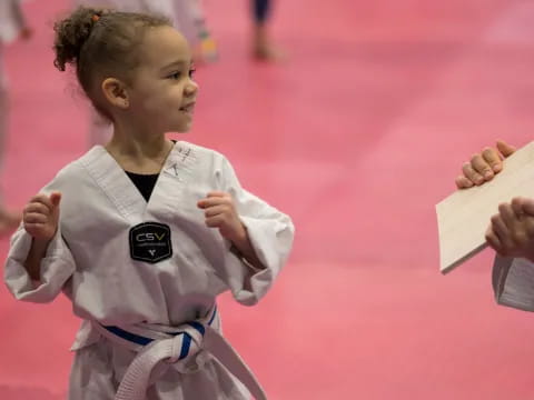 a young girl holding a book