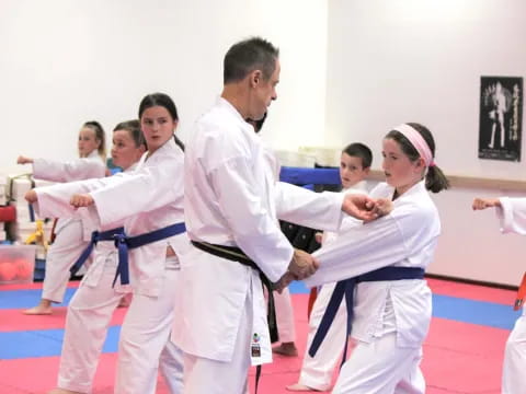 a group of people in karate uniforms