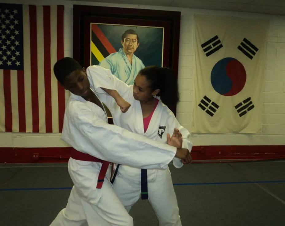 a man and woman in karate uniforms