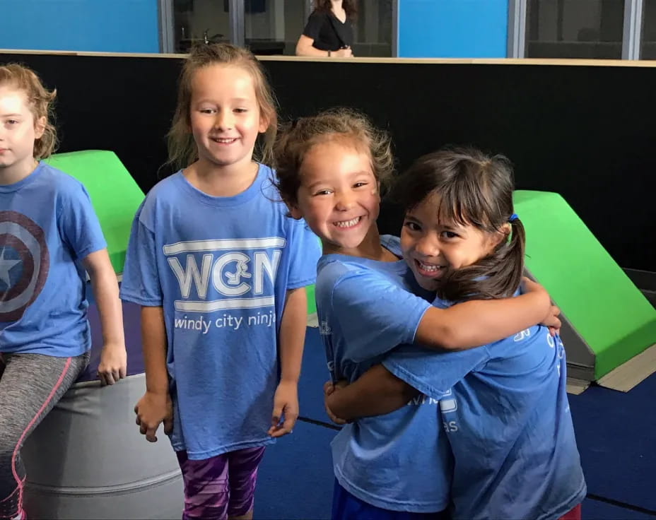a group of children in blue shirts