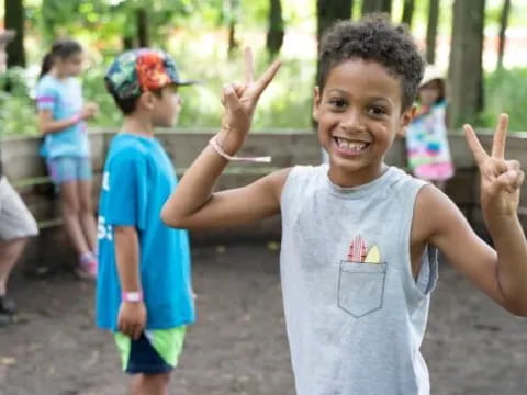 a young girl holding up two fingers