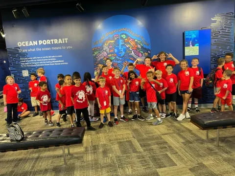 a group of children in red shirts