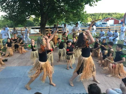 a group of women dancing in front of a crowd