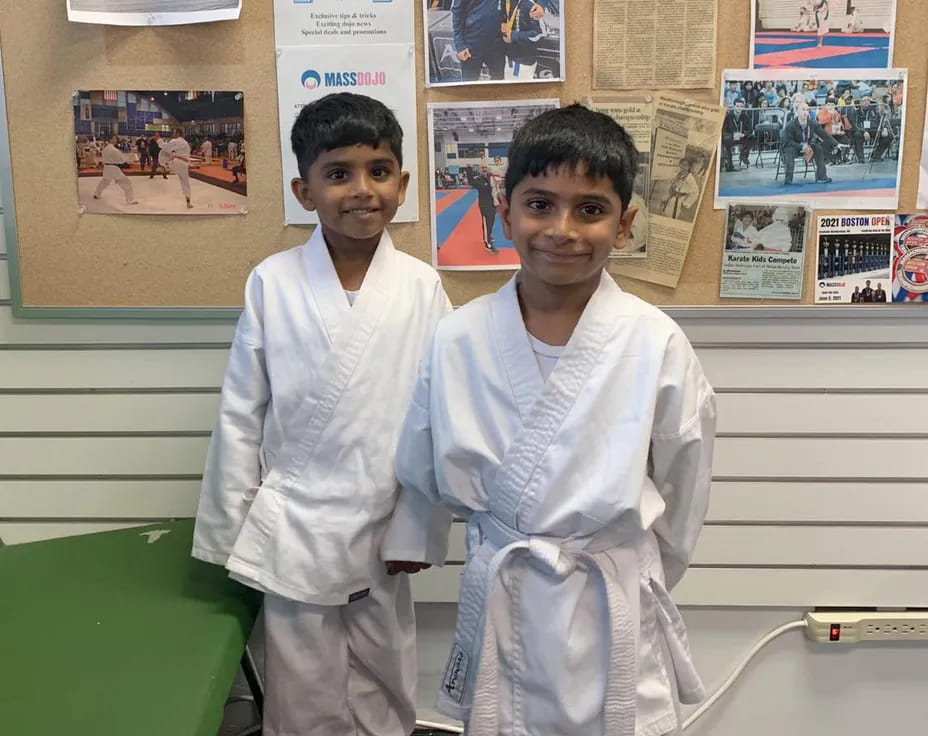 two boys in white lab coats