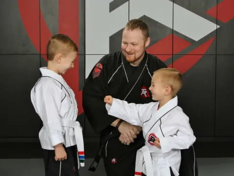 a man holding two boys
