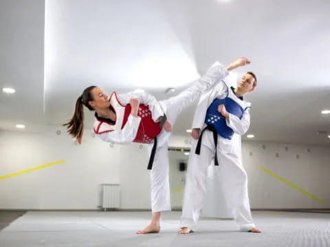 a man and woman in karate uniforms