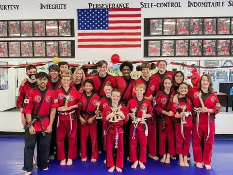 a group of people in red karate uniforms posing for a photo