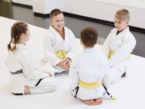 a group of children in karate uniforms