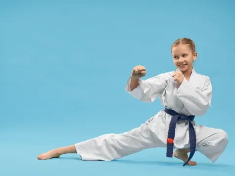 a young girl in a karate uniform