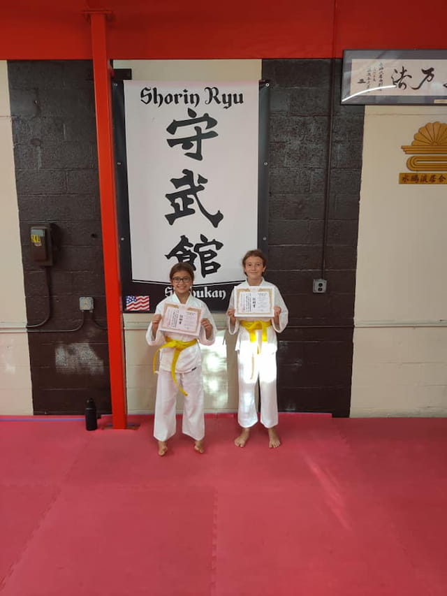 two boys in karate uniforms