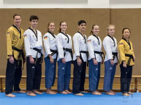 a group of people in white shirts