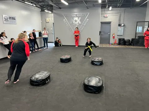 a group of people in a room with luggage